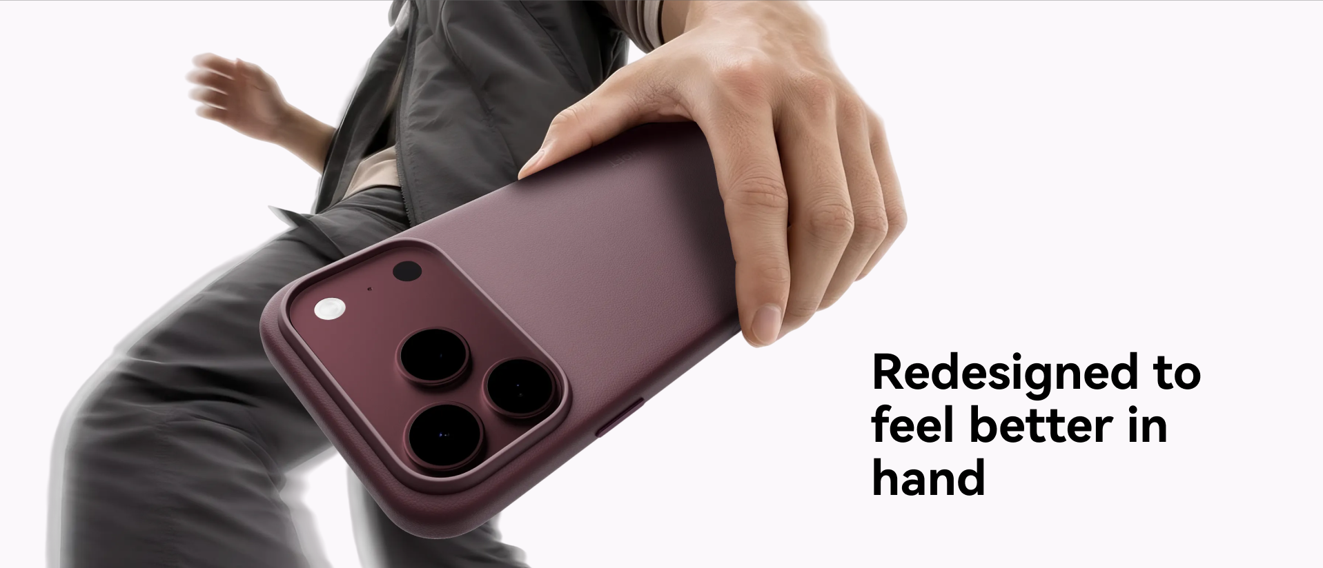 Hand holding the MOFT Snap Case MOVAS for iPhone 18 in a burgundy colourway